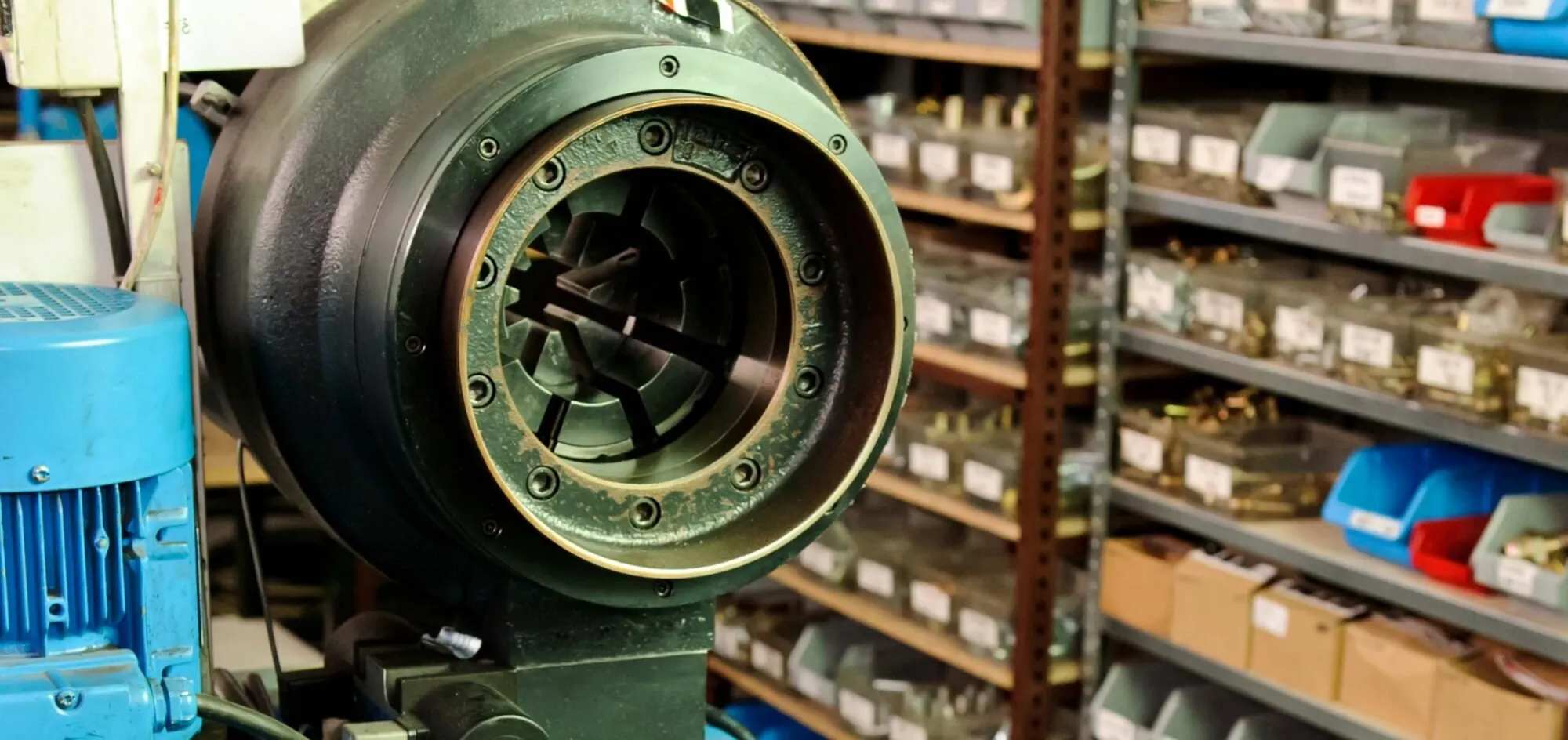 Hydraulic hose crimping machine in front of shelves stocked with fittings — cover image for the ASAP Hydraulics website project