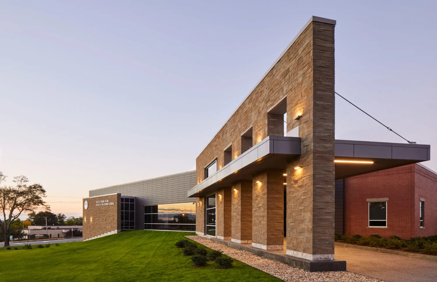 Modern stone-clad civic building exterior at dusk
