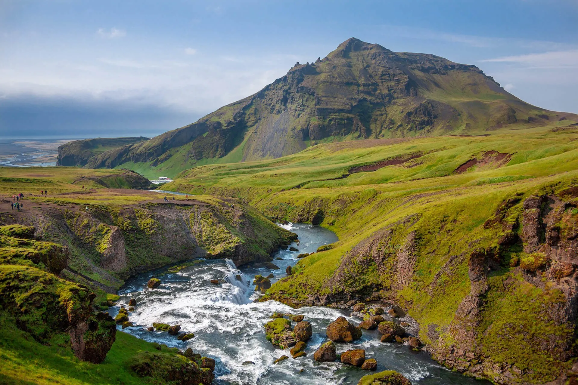 Green mountain valley with a rushing river and cascades below a rugged peak — cover image for the POWRA website project